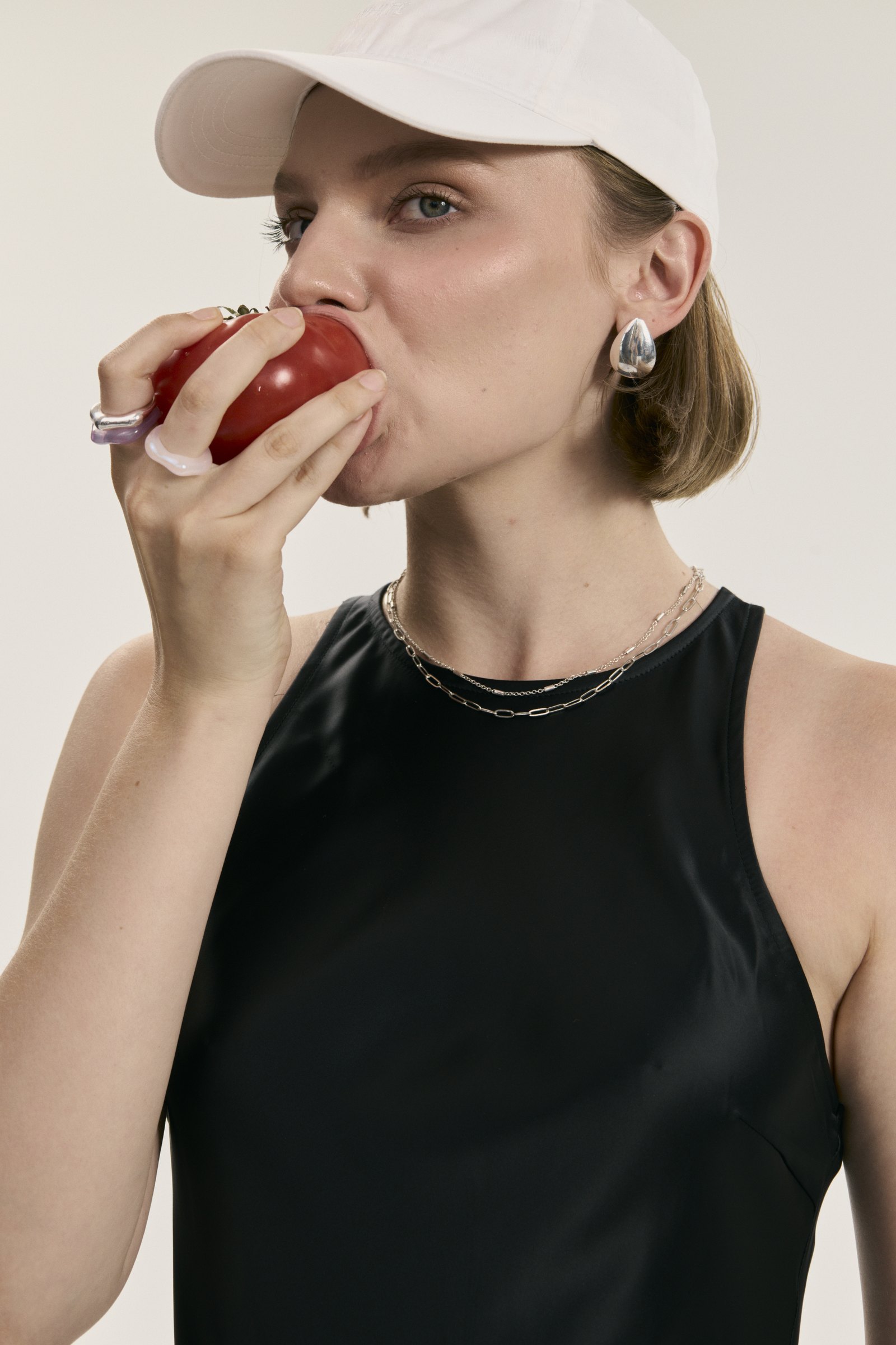 Model biting a tomato