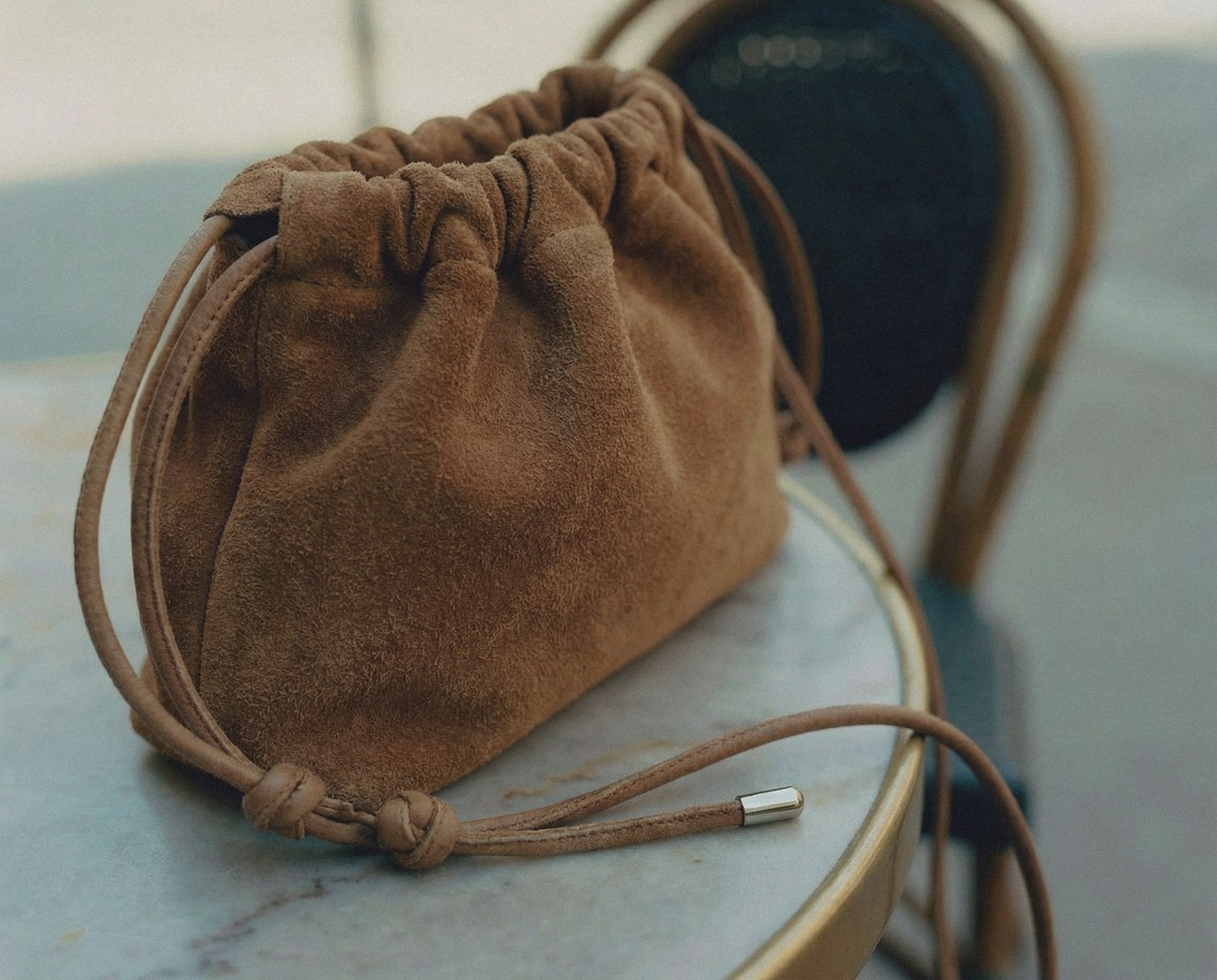Suede pouch on a marble table
